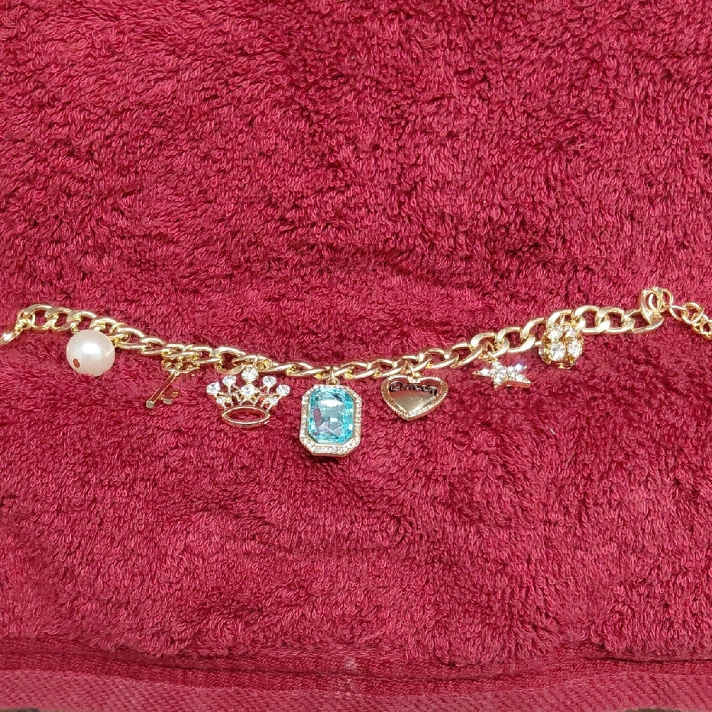 Gold Charm Bracelet with Blue Gemstone And Other Charms